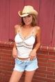 All-American girl in Cowboy hat and low-cut tank top