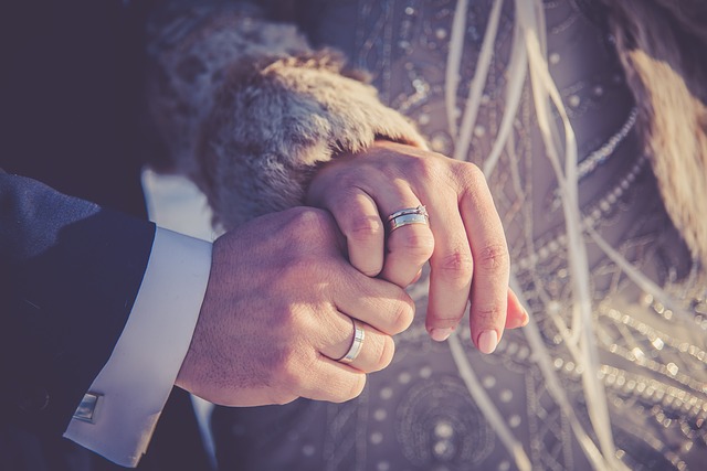 wedding bands on couple's hands