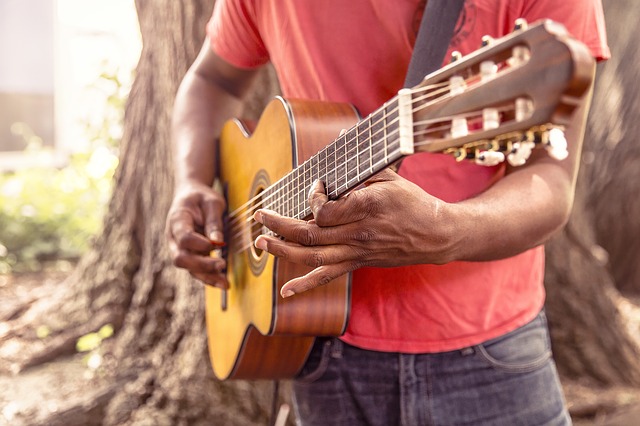 man with guitar in t-shirt