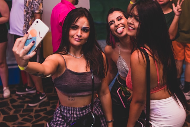 three beautiful women partying and taking a selfie