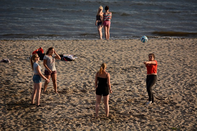 women on the beach playing with volleyball