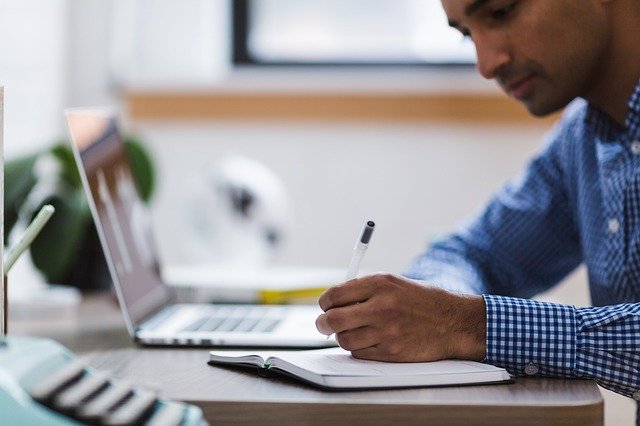 man with laptop and notebook