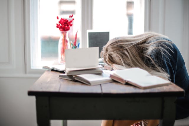 woman with face on desk