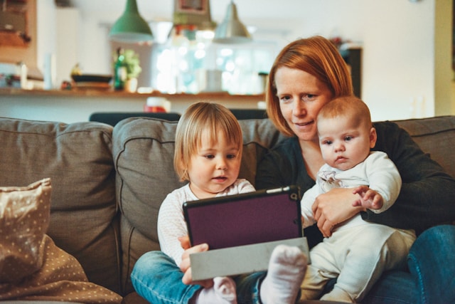 mom and young kids on the couch