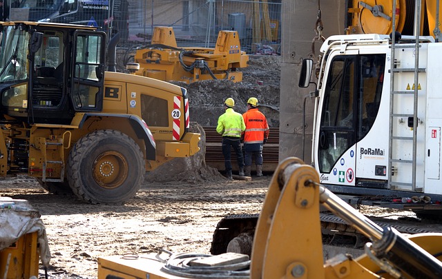 construction site with workers and heavy equipment