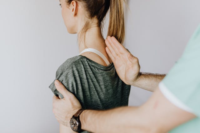 woman getting back examination