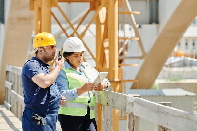 male and female workers on construction site