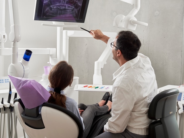 dentist with patient review x-ray