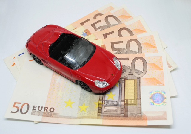 toy sports car on top of paper money