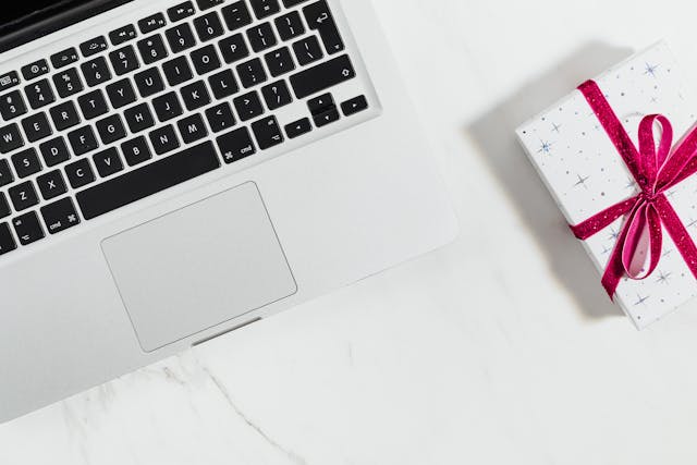laptop and wrapped gift box on table