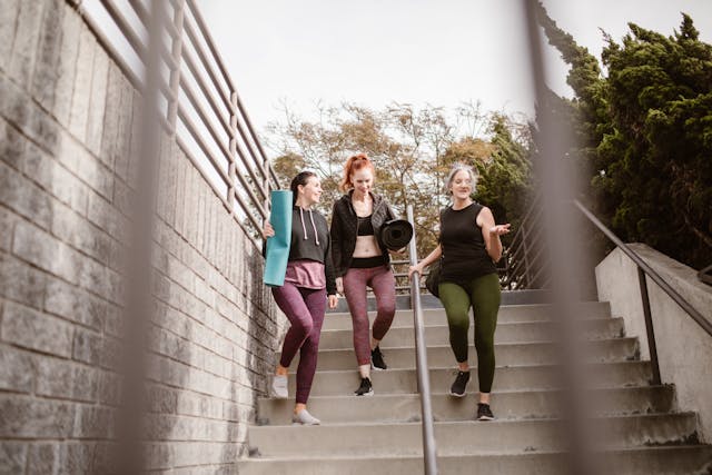 group of four women walking down steps outside