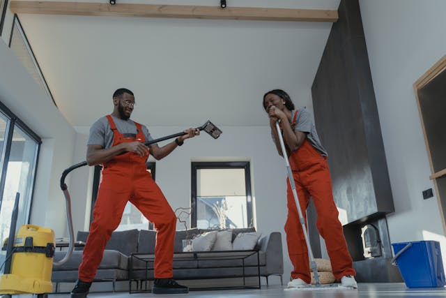 man and woman in orange jumpsuits cleaning home