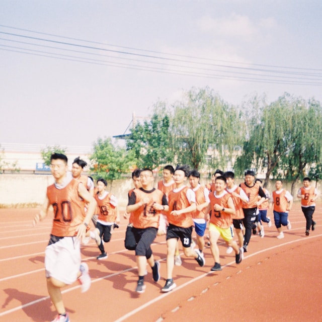 group of young men running track
