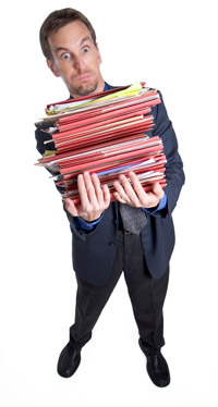 man holding a stack of folders