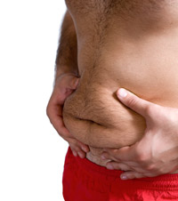 closeup of man with no shirt squeezing his belly with his hands