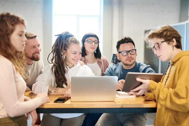 people at table looking at computers
