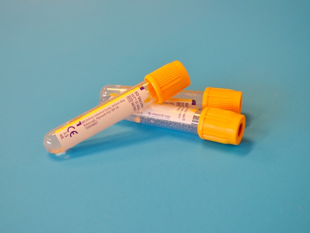 white and orange tubes for collecting blood
