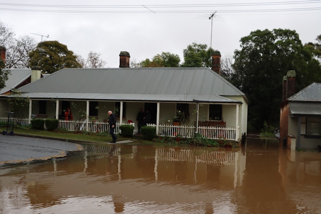 white house with porch with flooding