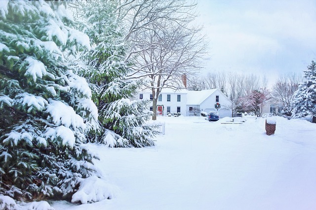 white house in middle of snow filled yard with trees with snow