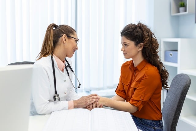 female doctor holding hands of female patient