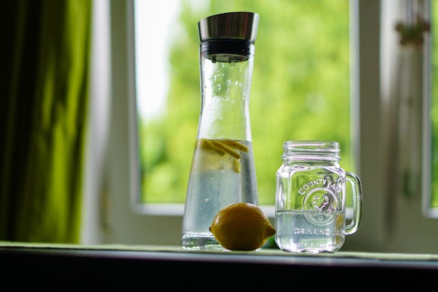lemon and bottle of water with glass