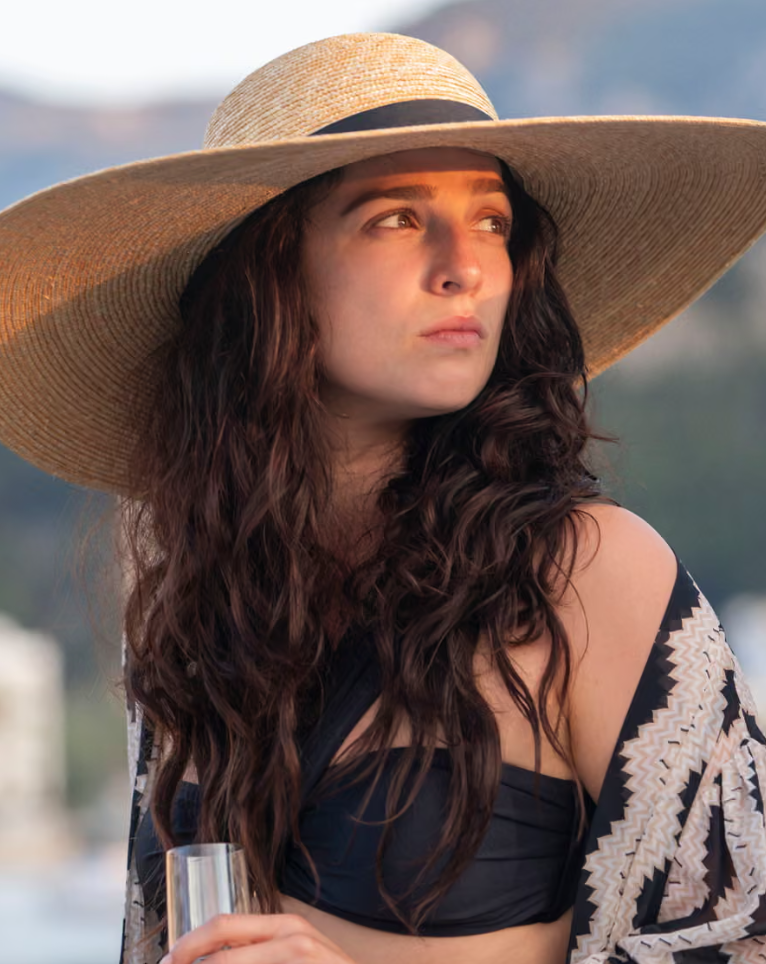 Marisa Abela in Industry wearing big hat