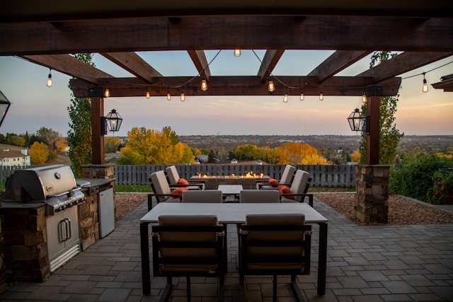 brown wooden table and chairs on deck with view