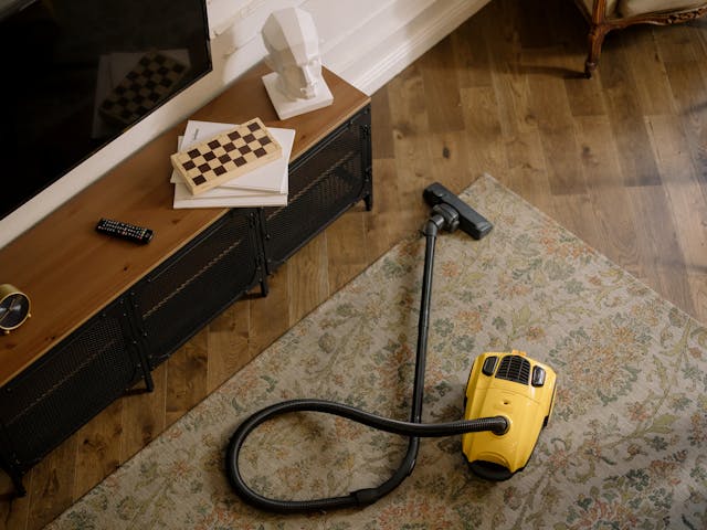 yellow and black vacuum cleaner on carpet