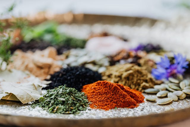 closeup of colorful herbs and spices on a wood surface