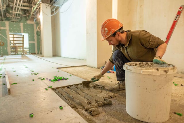 construction worker laying tile