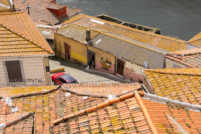 ariel views of homes and red car on road