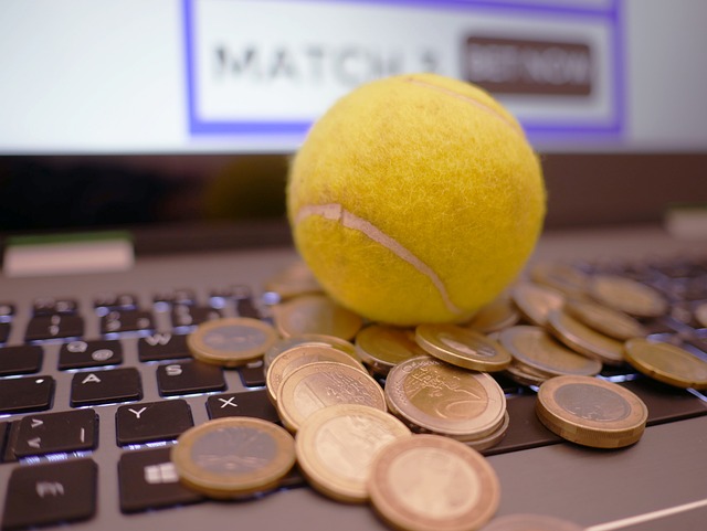 tennis ball and coins on laptop keyboard