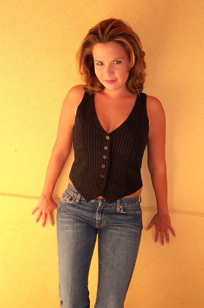 Amber in black vest and jeans with golden natural light
