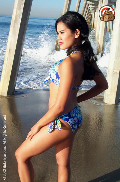 Jazmine in flowery bikini at Hermosa Beach under the dock side view