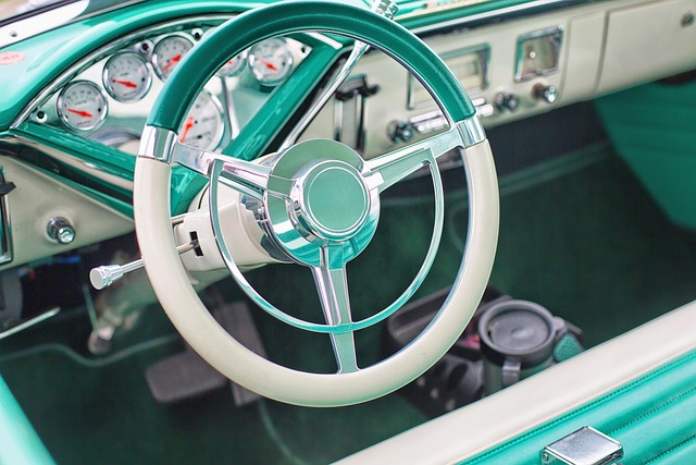 turquoise and white steering wheel and dashboard of classic car