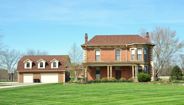 large house with green lawn and driveway