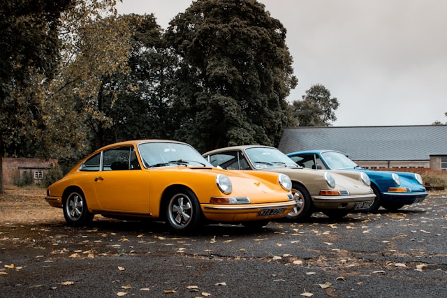 classic prsche sports cars in yellow gray and blue
