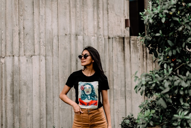 brunette woman in black t-shirt with design