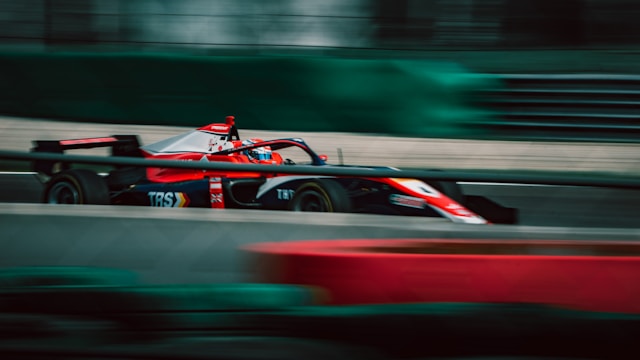 red Formula 1 car on course