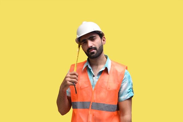 maintenance worker in hard hat and orange vest