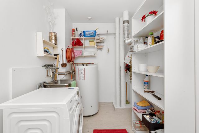 utility room with water heater