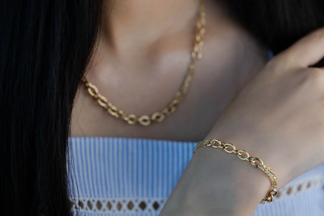 close-up of woman with gold necklace and bracelet