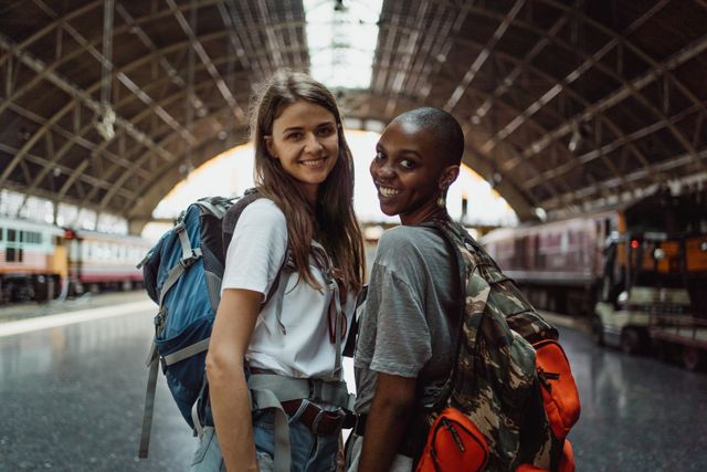 two pretty female travelers in train station