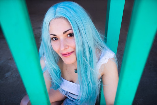 pretty woman in white top with blue hair