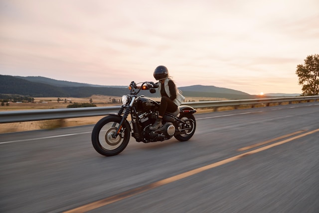 man on motorcycle on road