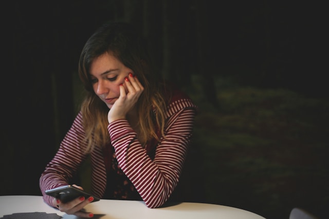 pretty brunette woman holding smartphone