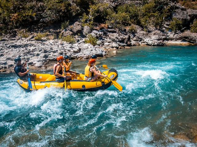 four people in raft on river