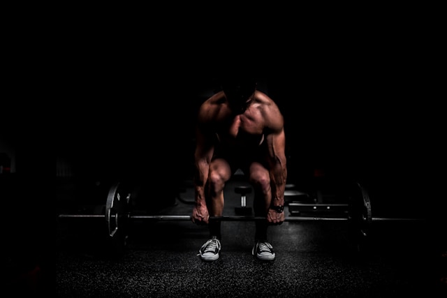 muscular man deadlifting weights