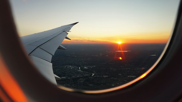 view of sunrise from plane window