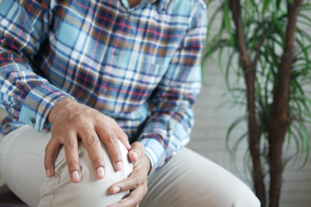 close-up of man holding his knee